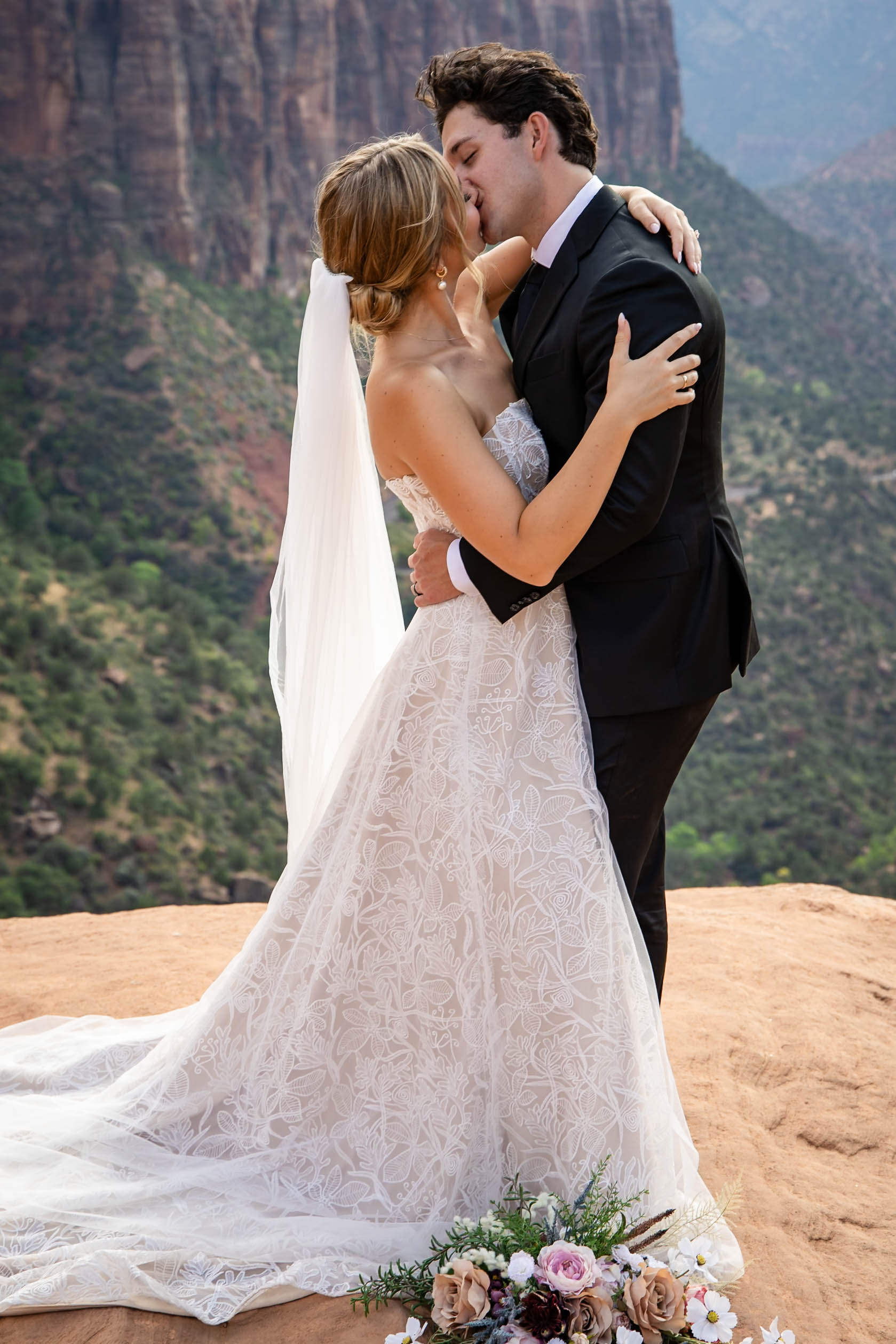 bride-and-groom-standing-on-top-mount-Zion-kissing