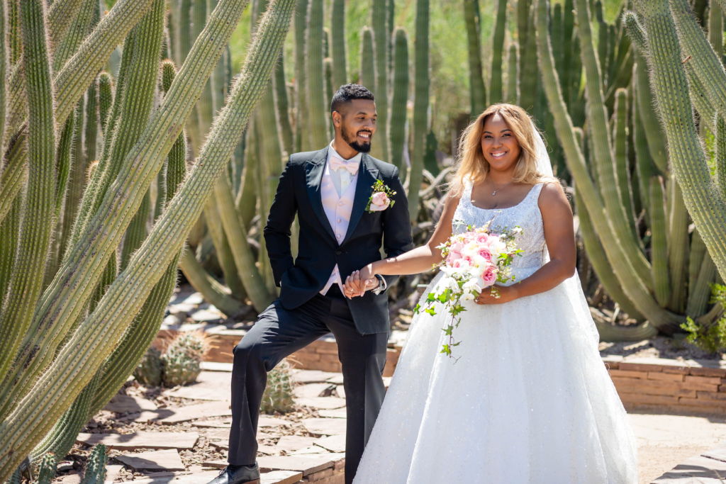 Bride ana Groom taking pictures at Desert Botanical Garden in phoenix