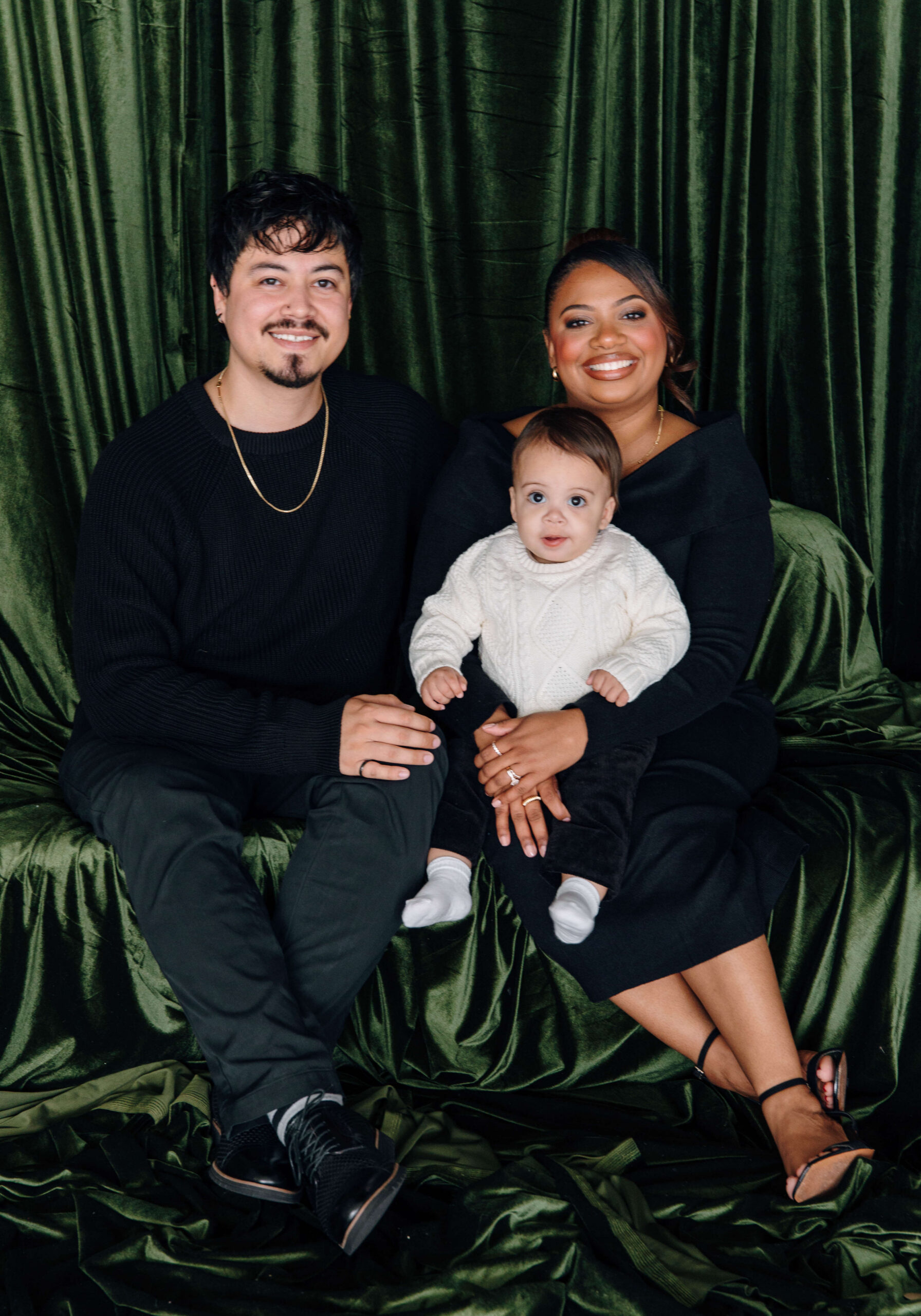 mom and dad and baby taking Christmas photos